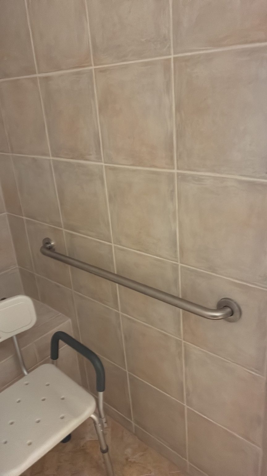 Grab bar installed on tiled shower wall in Naples